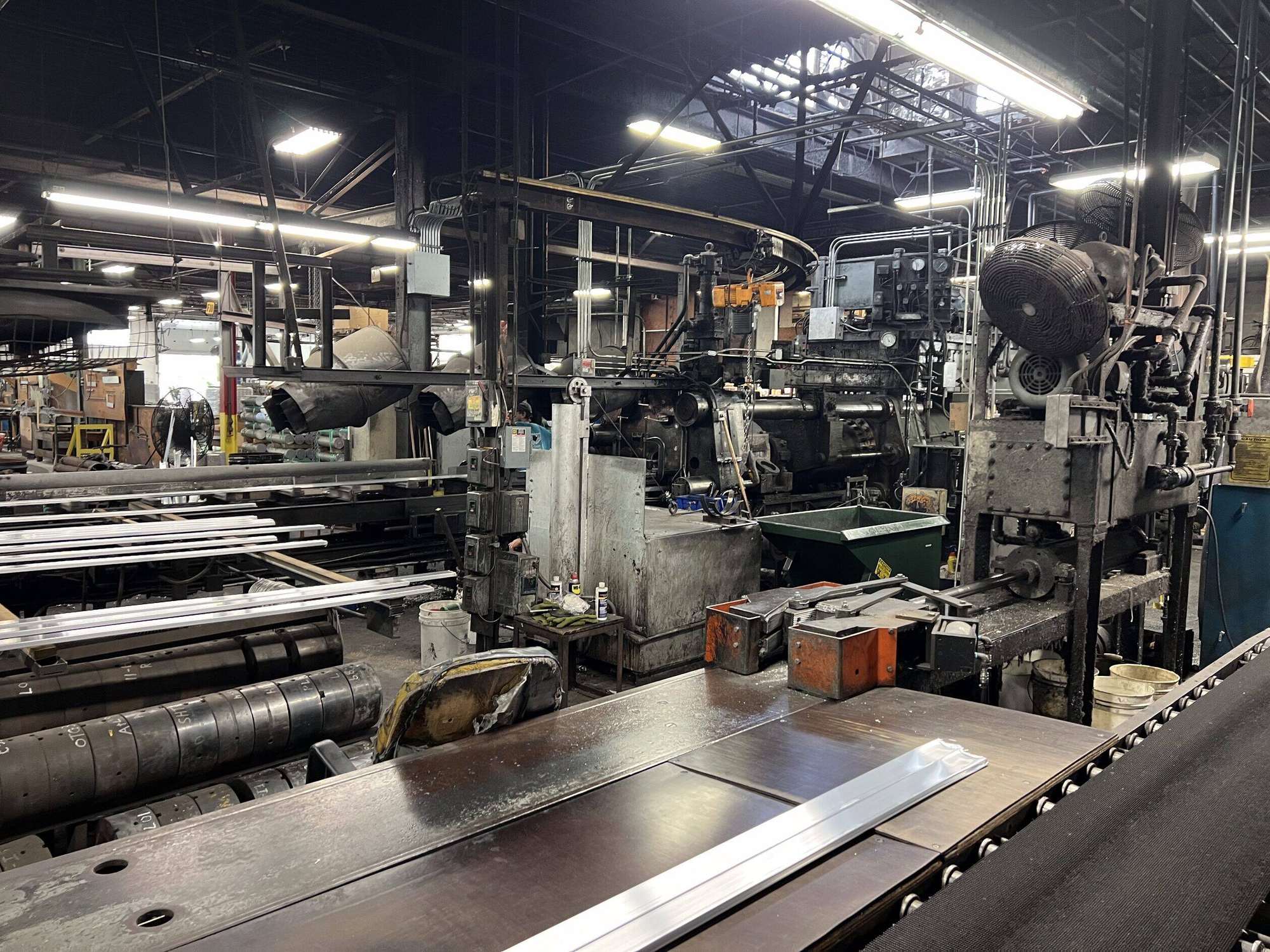 AES operators running the aluminum extrusion press and run-out table on the Cincinnati floor