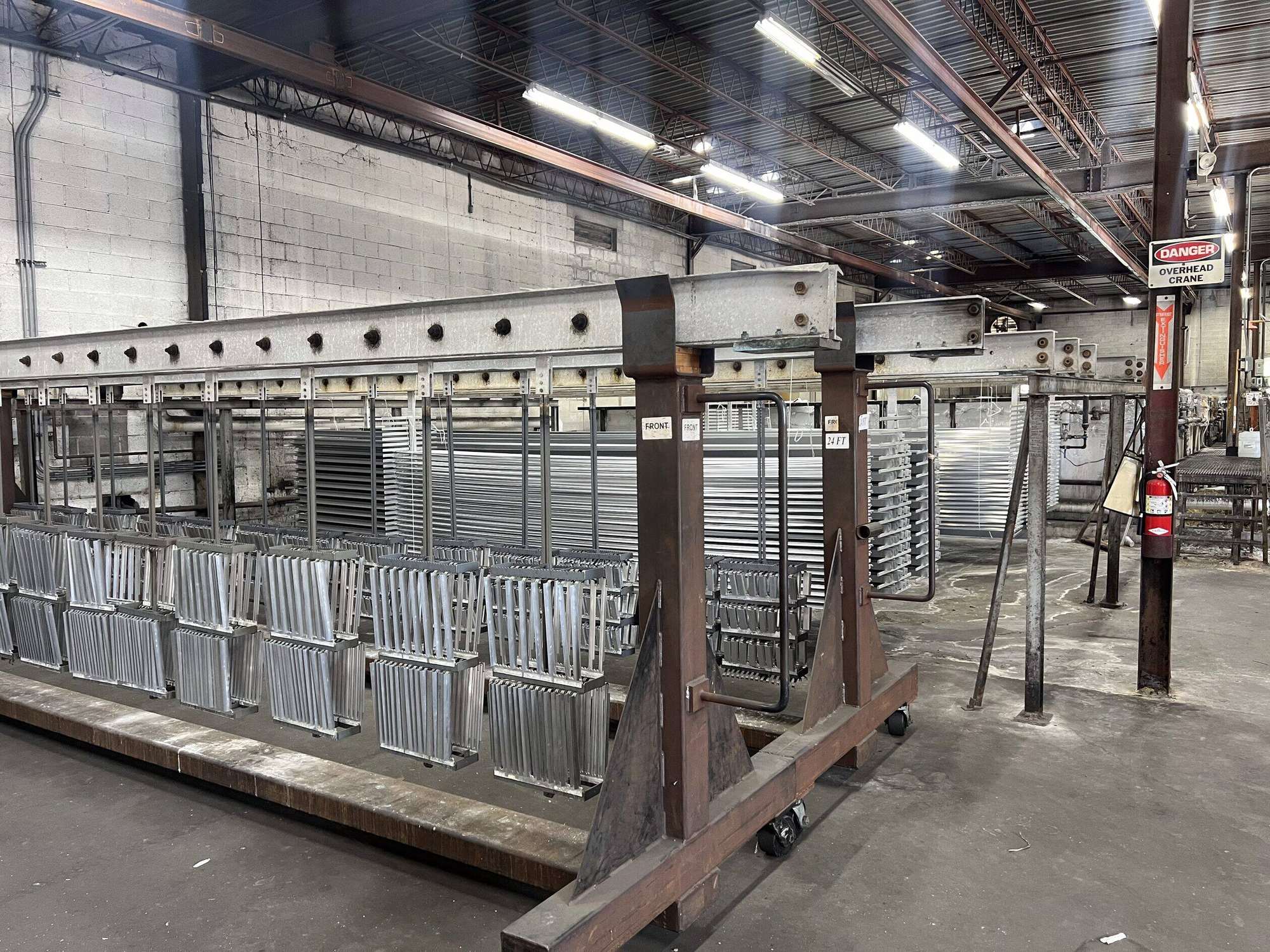 Racked finished aluminum profiles along the finishing line at AES