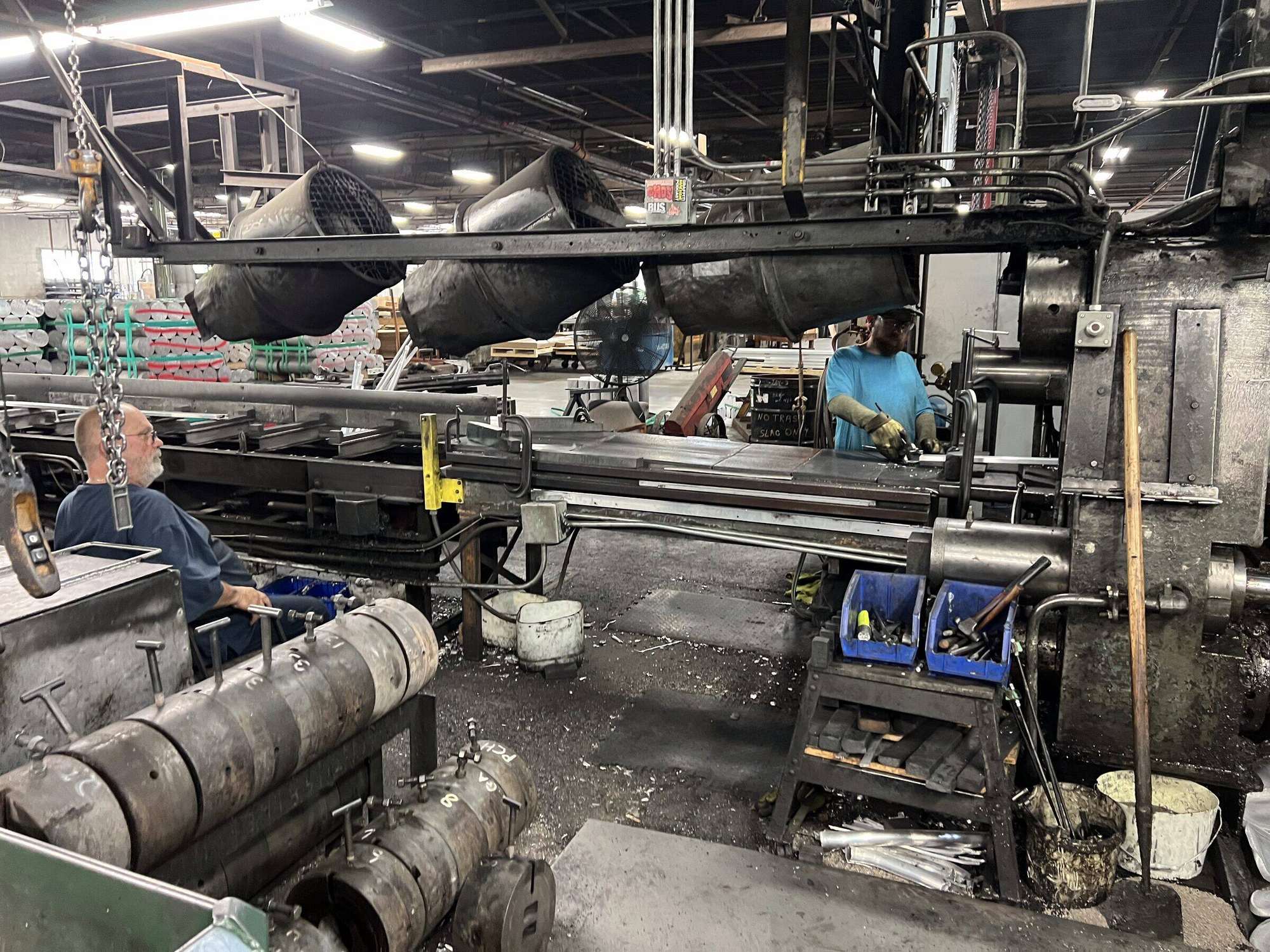 An AES operator running the aluminum extrusion press on the Cincinnati floor